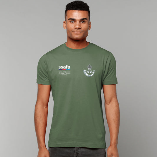 A man wearing a military green t-shirt showing an MOD licensed The Rifles (King's Crown) insignia to left chest and SSAFA logo to right chest.