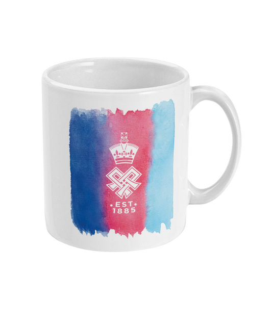A white ceramic mug featuring a vertical watercolor design in navy, red, and light blue, with a white coat of arms and the text 'EST. 1885' printed in the center.