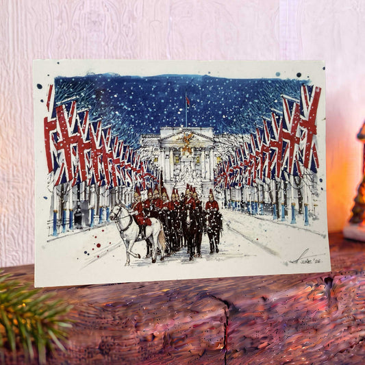 Christmas card on mantelpiece with a parade of Life Guards down the Mall in front of Buckingham Palace.