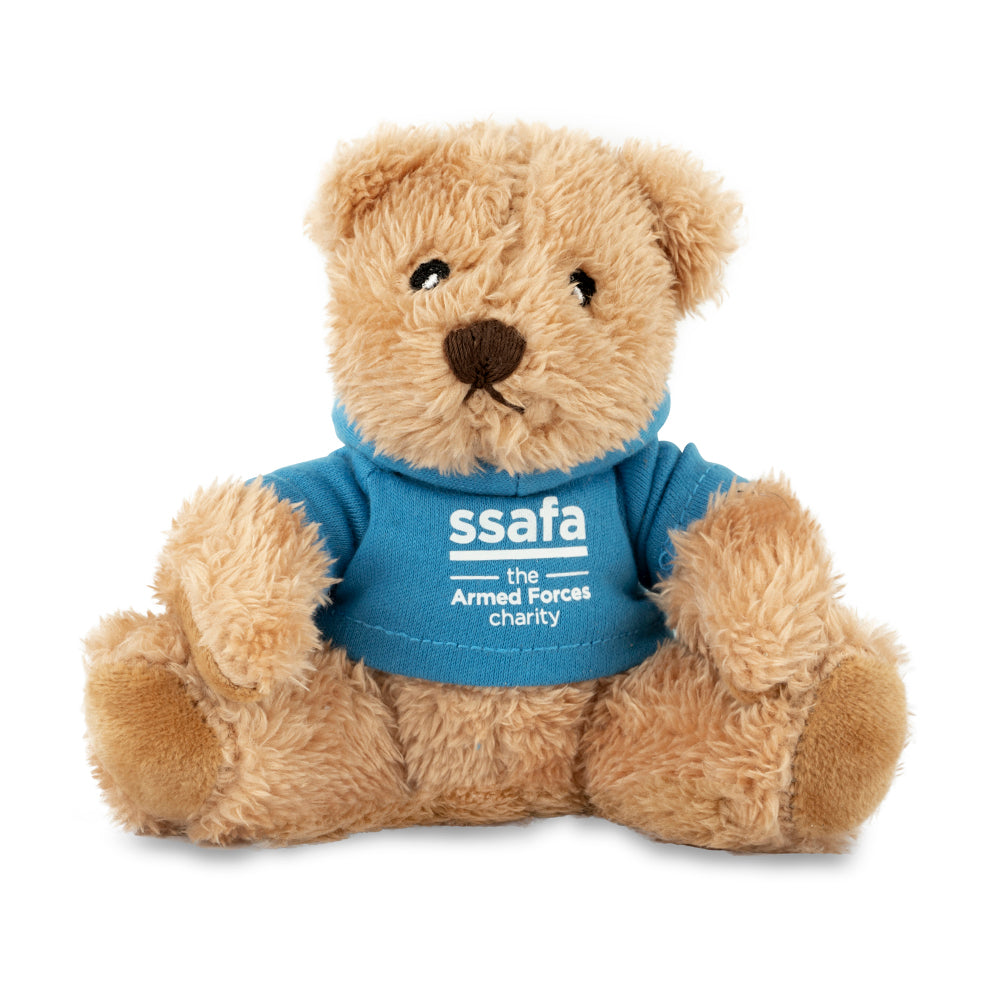 Teddy bear wearing a blue shirt with 'SSAFA the Armed Forces charity' logo on a white background