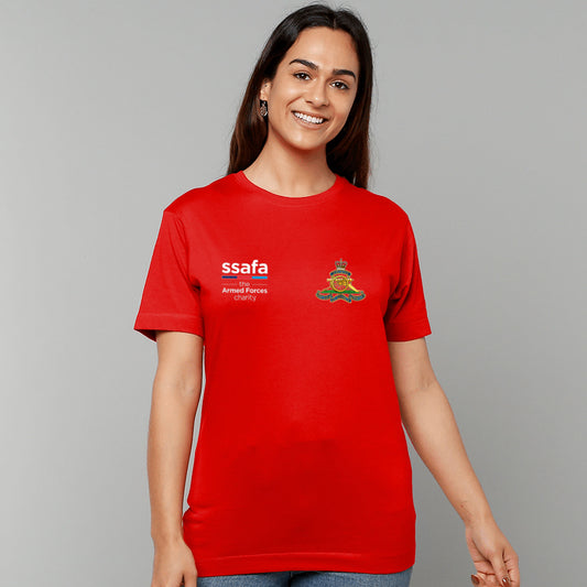 A woman wearing a red short-sleeve t-shirt with 'ssafa' and Royal Artillery insignia printed on the chest, photographed against a solid grey studio background.
