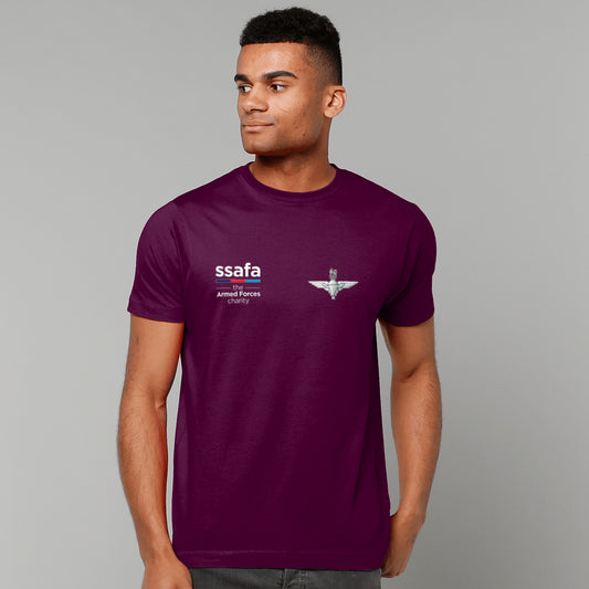 A man wearing a maroon short-sleeve t-shirt with 'ssafa' and Parachute Regiment insignia printed on the chest, photographed against a solid grey studio background.