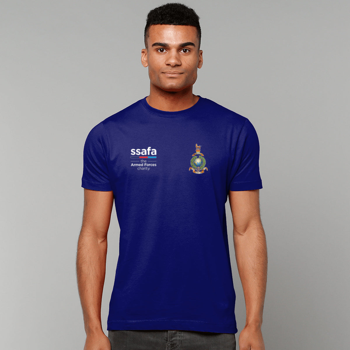 A man wearing a navy t-shirt showing an MOD licensed Royal Marines (King's Crown) insignia to left chest and SSAFA logo to right chest.