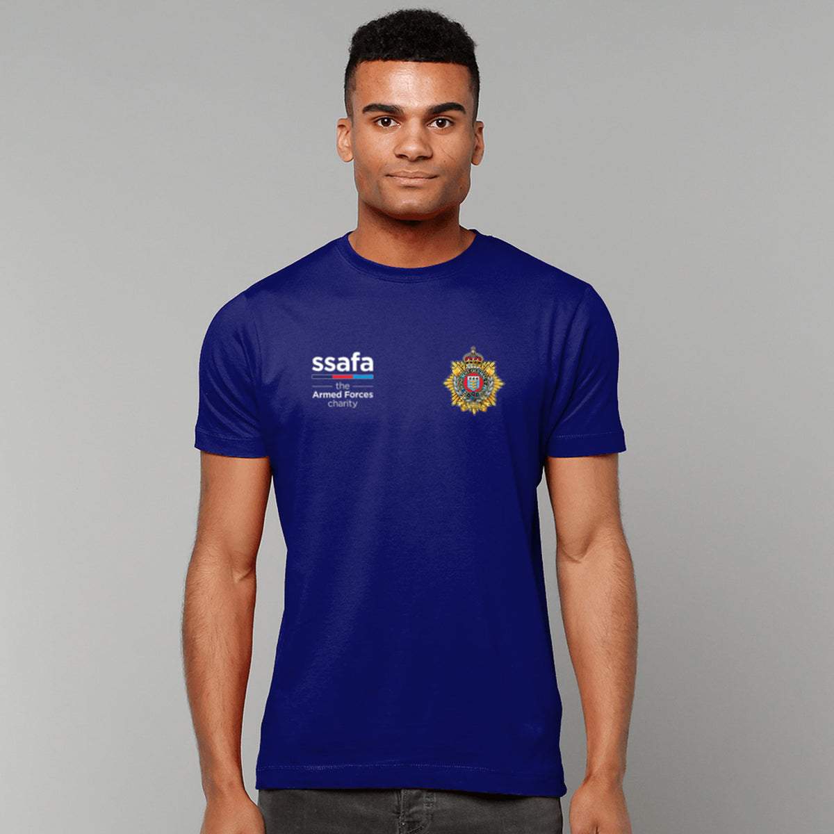 A man wearing a navy t-shirt showing an MOD licensed Royal Logistics Corps (King's Crown) insignia to left chest and SSAFA logo to right chest.