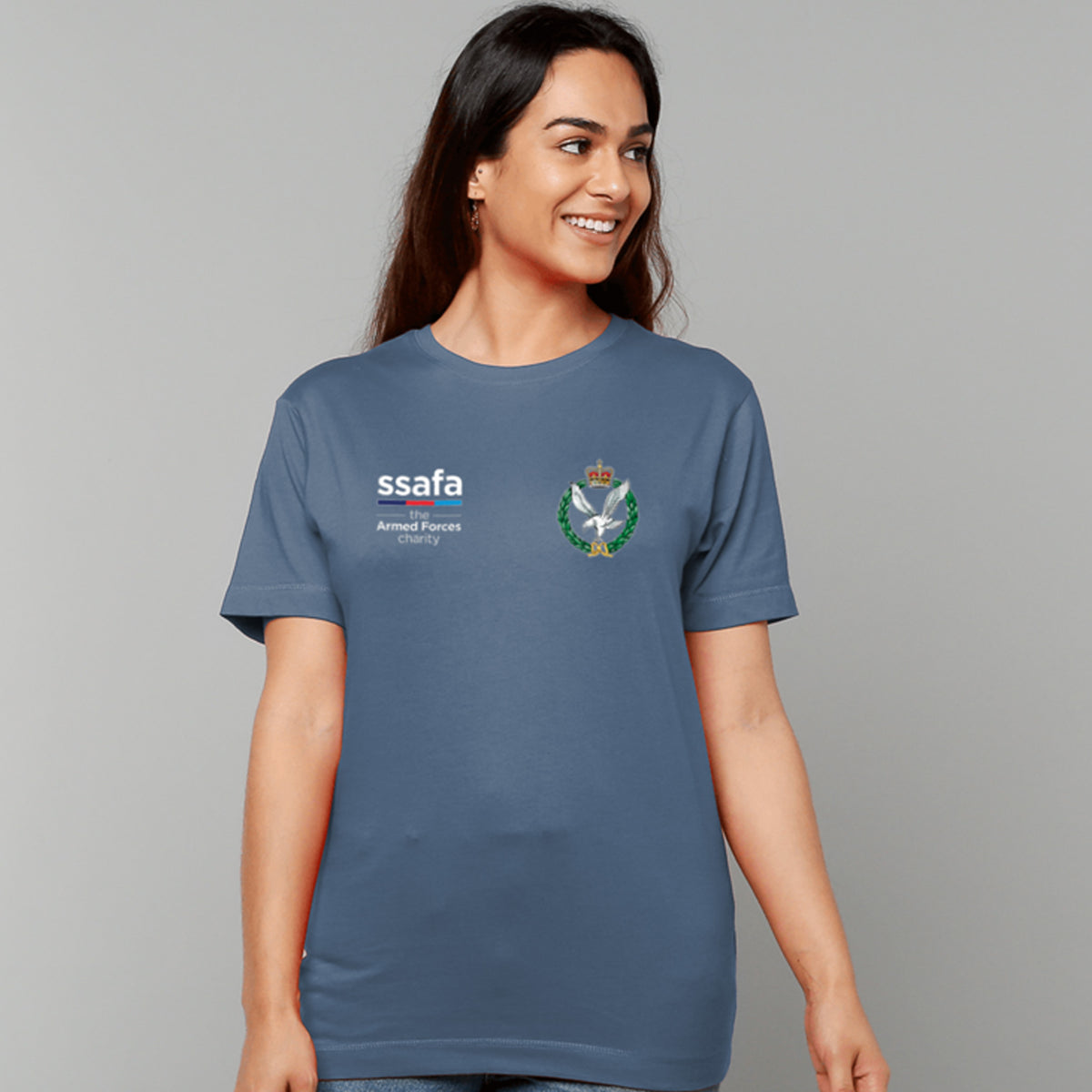 A woman wearing an indigo blue t-shirt showing an MOD licensed Army Air Corps (Queen's Crown) insignia to left chest and SSAFA logo to right chest.