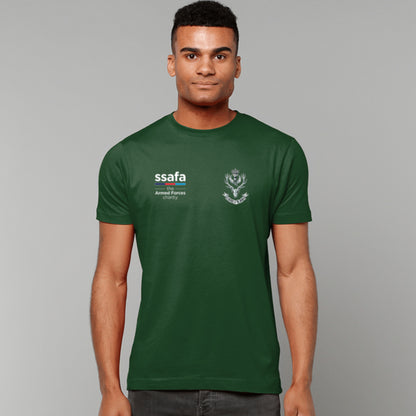 A man wearing a forest green t-shirt showing a MOD licensed Queen's Own Highlanders (Queen's Crown) insignia to left chest and SSAFA logo to right chest.