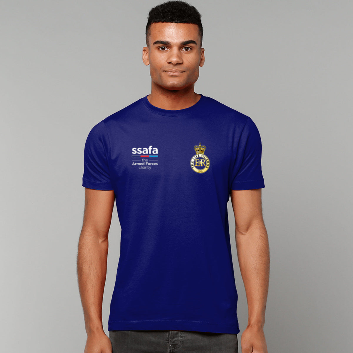 A man wearing a navy t-shirt showing an MOD licensed The Life Guards (Queen's Crown) insignia to left chest and SSAFA logo to right chest.