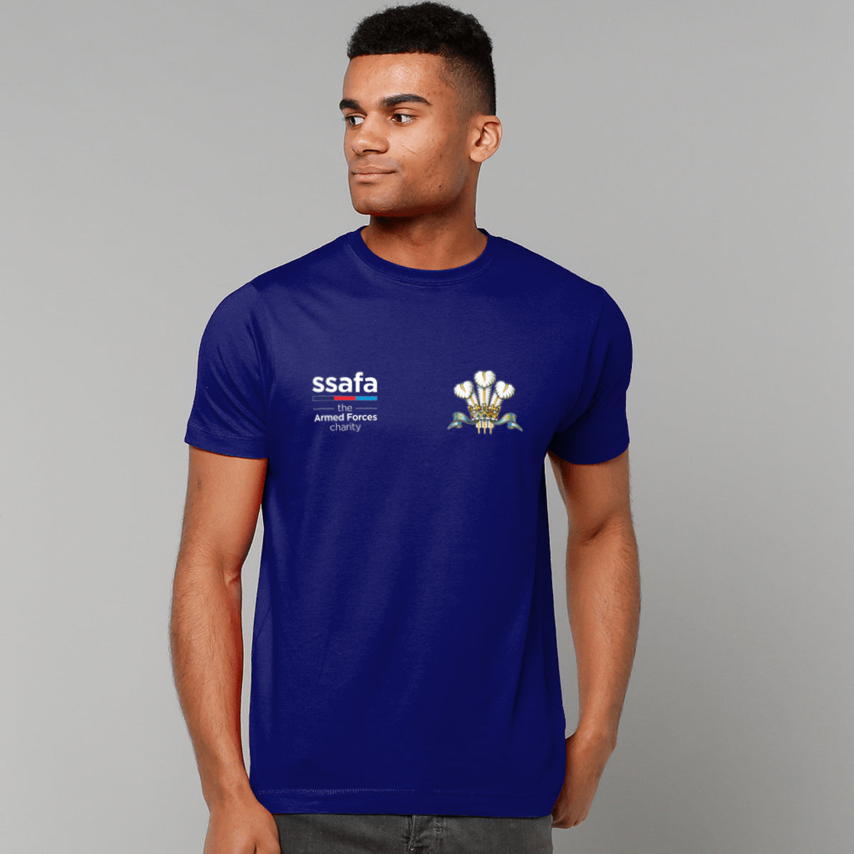 A man wearing a navy t-shirt showing an MOD licensed Royal Regiment of Wales insignia to left chest and SSAFA logo to right chest.