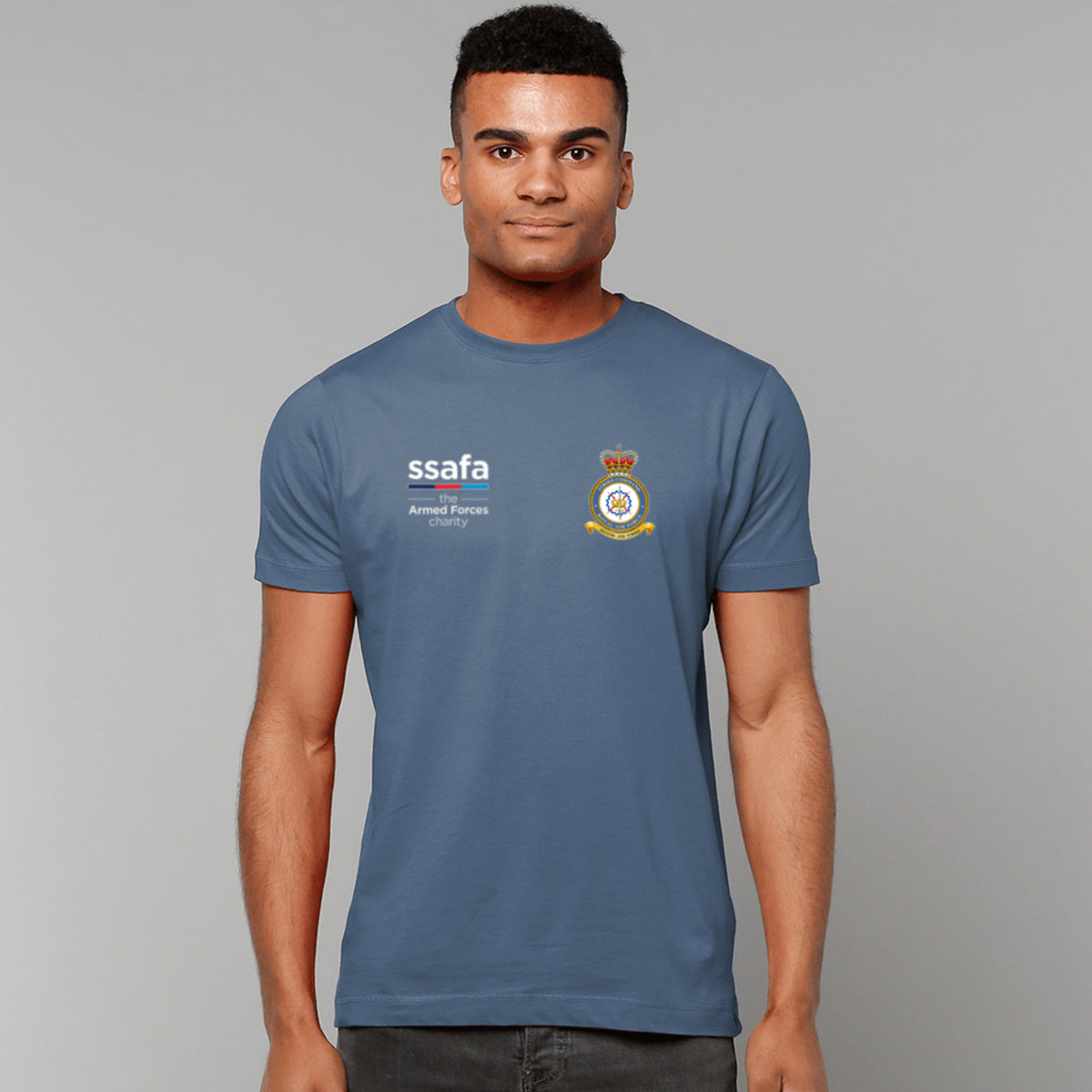 A man wearing an indigo blue t-shirt showing an MOD licensed RAF Strike Command (Queen's Crown) insignia to left chest and SSAFA logo to right chest.