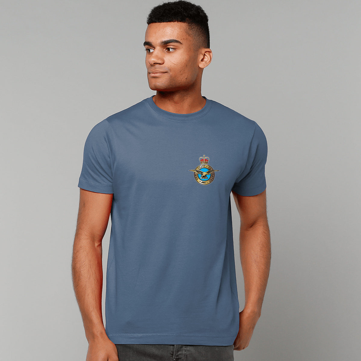 A man wearing an indigo blue t-shirt showing an MOD licensed RAF (Queen's Crown) Insignia to left chest.
