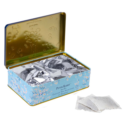 A Peter Rabbit English Tea Collection 72 Teabags in a decorative blue tin, with two individual white tea bags shown in front on a white background.