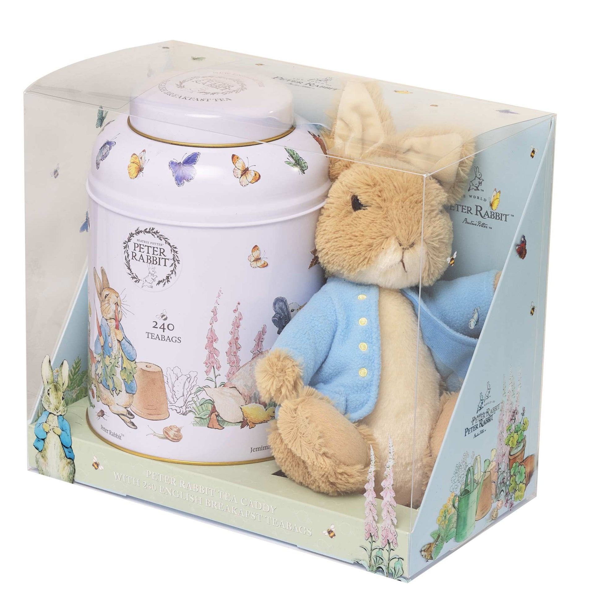 Peter Rabbit tea tin gift set in a clear plastic box, featuring a white illustrated tea tin and a plush Peter Rabbit figure in a blue jacket.