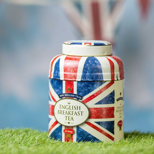 Tea canister with British flag design on grass