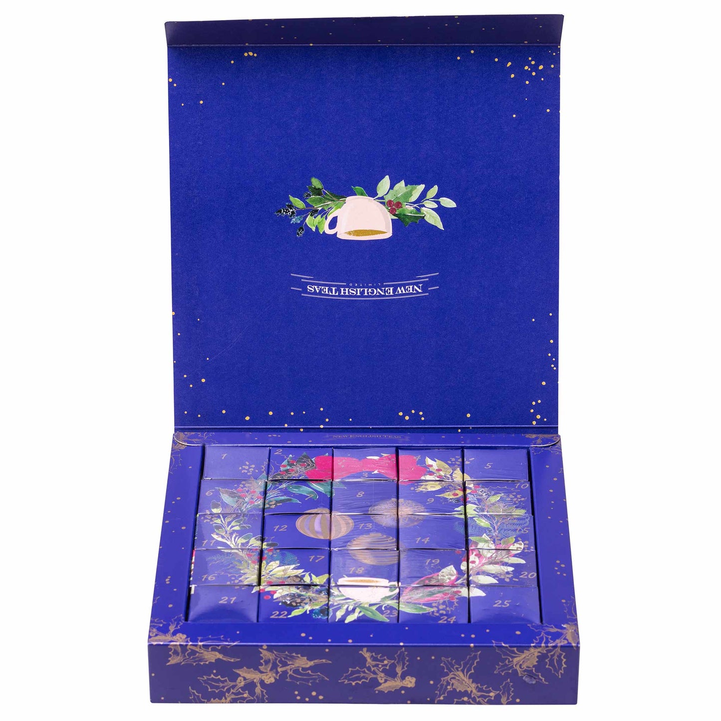 An open royal blue gift box containing six individually boxed tea bags, decorated with gold foil stars and a wreath design on the lid.