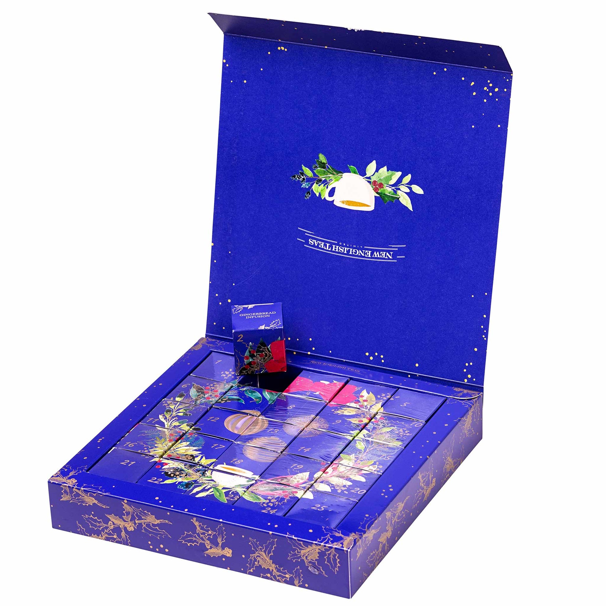 An open blue gift box containing assorted packaged tea bags, with decorative gold and green floral accents on the box and tea packaging, shown on a plain white background.