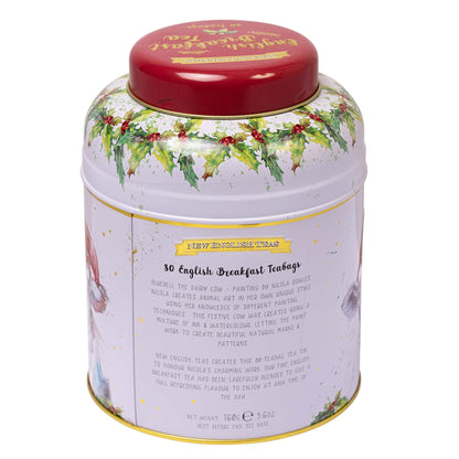 A round metal tea tin with a red lid and a white body decorated with green holly leaves, red berries, and gold speckles. The front label reads '50 English Breakfast Tea Bags'.