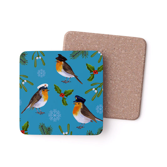 Coaster with military Robin design on a blue background, showing cork back. Patterned coaster with 3 Robins each wearing a hat of the Army, Royal Navy and RAF, with holly and mistletoe and holly on a blue background.