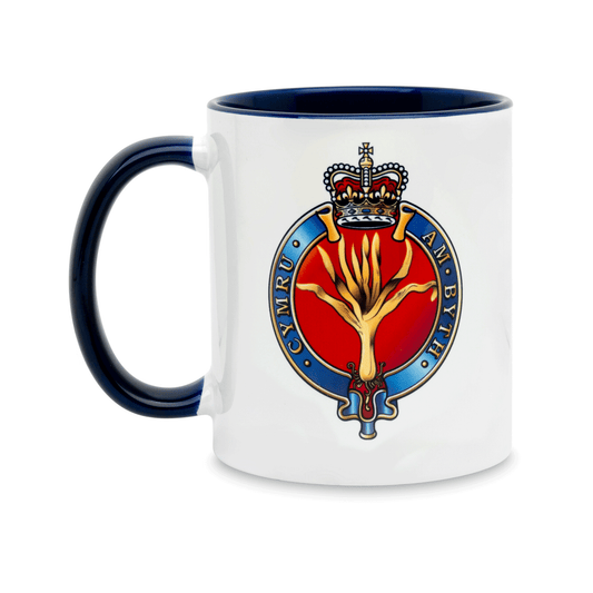 A white ceramic mug with a navy handle and interior, featuring a printed insignia of the Welsh Guards on the front. Set against a plain white background.