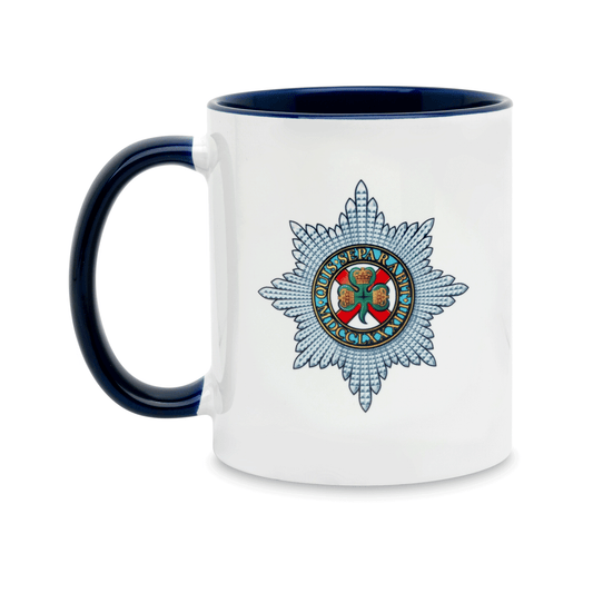 A white ceramic mug with a navy handle and interior, featuring a printed insignia of the Irish Guards on the front. Set against a plain white background.