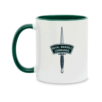 A white ceramic mug with a dark green handle and interior, featuring a printed insignia of the Royal Marines Commando on the front. Set against a plain white background.