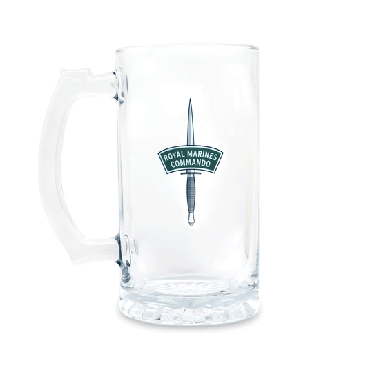 A clear glass beer stein mug with a handle, featuring a printed Royal Marines Commando dagger insignia in green and white on the front, set against a plain white background.