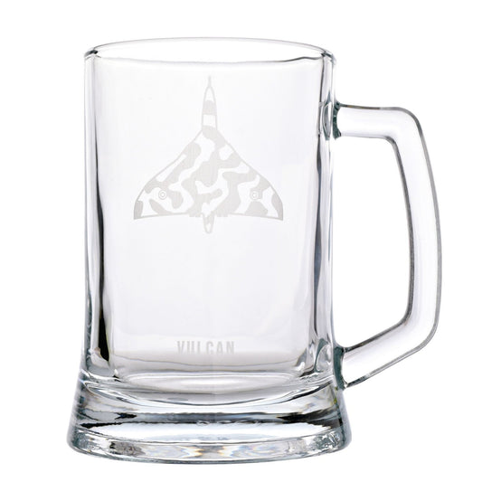 A clear glass beer mug with a handle, featuring an etched gray delta-shaped logo with a camouflage pattern and the word 'VULCAN' near the base, shown on a white background.