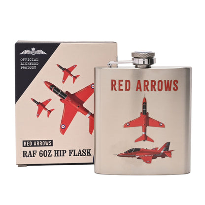 A 6oz stainless steel hip flask with a silver screw cap, featuring a red jet aircraft graphic and the words 'RED ARROWS' in red. It is shown next to its beige and black retail box, which also displays the same red aircraft illustration and 'OFFICIAL LICENSED PRODUCT' text.