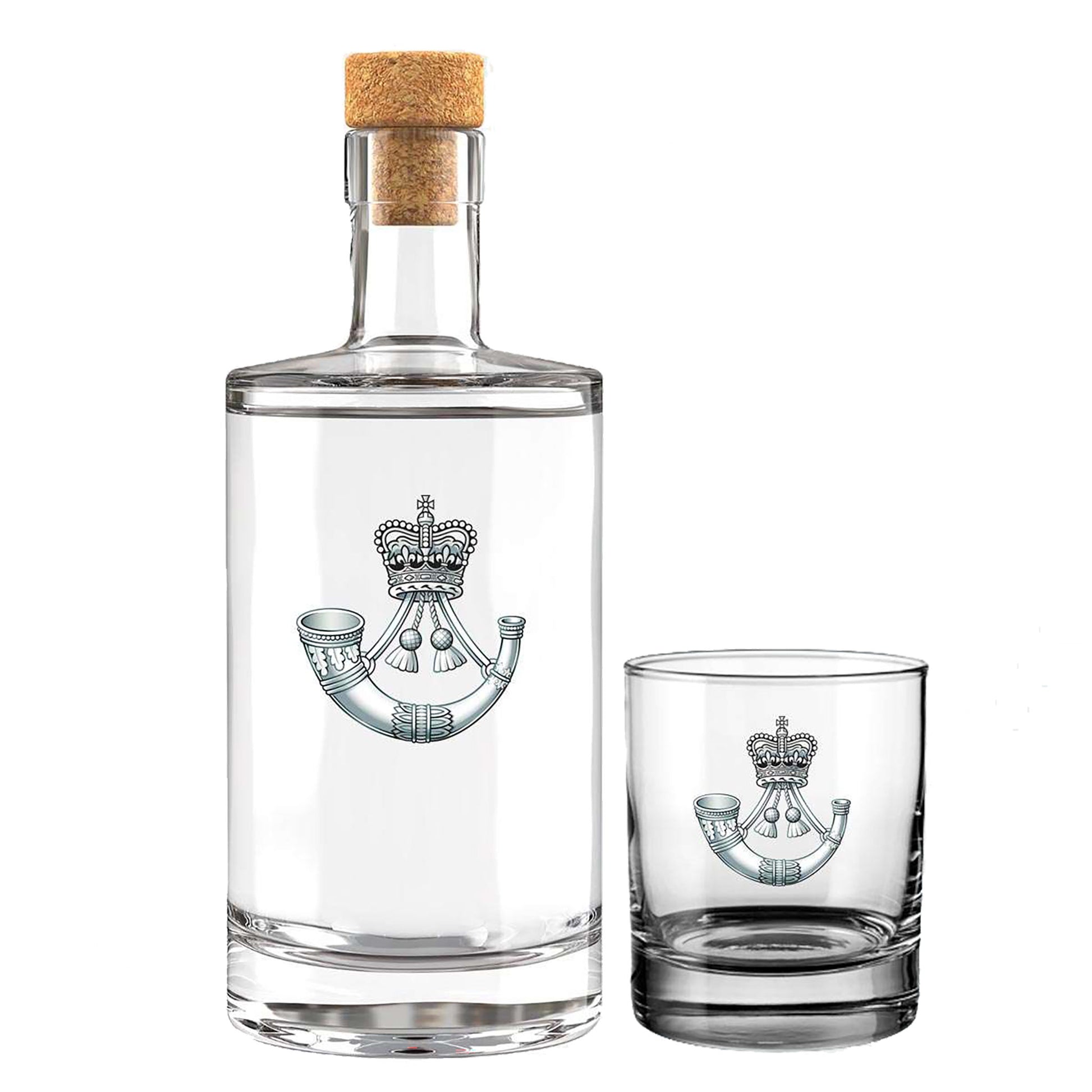 A clear glass bottle with a cork stopper and a matching clear glass tumbler, both printed with the insignia of The Rifles, shown on a plain white background.