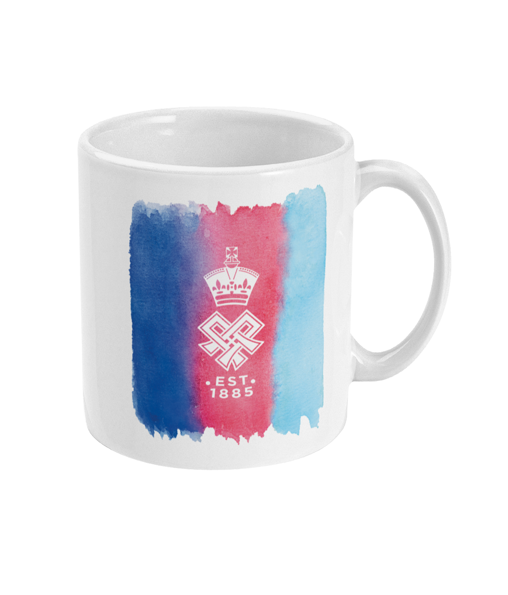 A white ceramic mug featuring a vertical watercolor design in navy, red, and light blue, with a white coat of arms and the text 'EST. 1885' printed in the center.