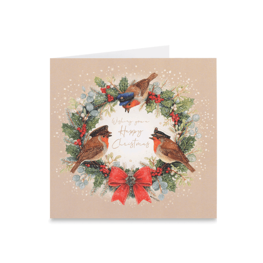 A square Christmas greeting card with a beige background, featuring an illustrated wreath with three robins wearing military hats of the Army, Navy and RAF,, red berries, a red bow, and the words 'Wishing you a Happy Christmas' in gold script.