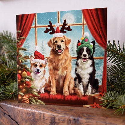 Square Christmas card on mantelpiece showing three dogs in reindeer antlers and red and green Santa hats, posed by a snowy window with red curtains.