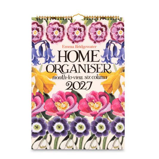 A 2027 wall calendar titled 'Home Organiser' by Emma Bridgewater, featuring a vibrant floral design with pink, purple, blue, and yellow flowers on a cream background, complete with a gold hanging loop at the top.