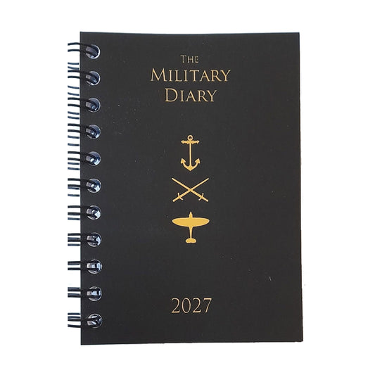 A black spiral-bound 2027 military-themed diary with gold foil lettering and insignia (anchor, swords, airplane) on a white background.