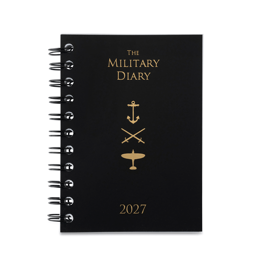 A black spiral-bound 2027 military-themed diary with gold foil lettering and insignia (anchor, swords, airplane) on a white background.