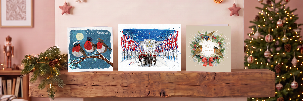 3 Christmas cards on a wooden mantelpiece: Life Guards on Parade and 2 cards with Robins wearing Military hats.
